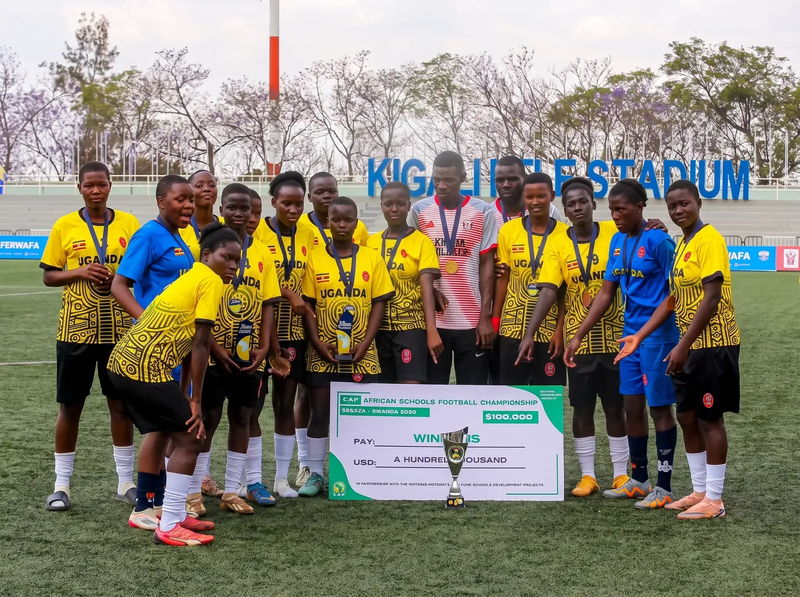 Amus College School girls' team with medals and trophy after winning bronze at the CECAFA CAF African Schools Football Championship qualifiers in Kigali, Rwanda, in 2026.