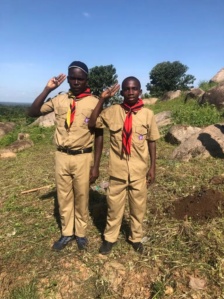 Amus College scouts saluting